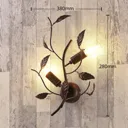 Metal wall light Yos adorned with leaves